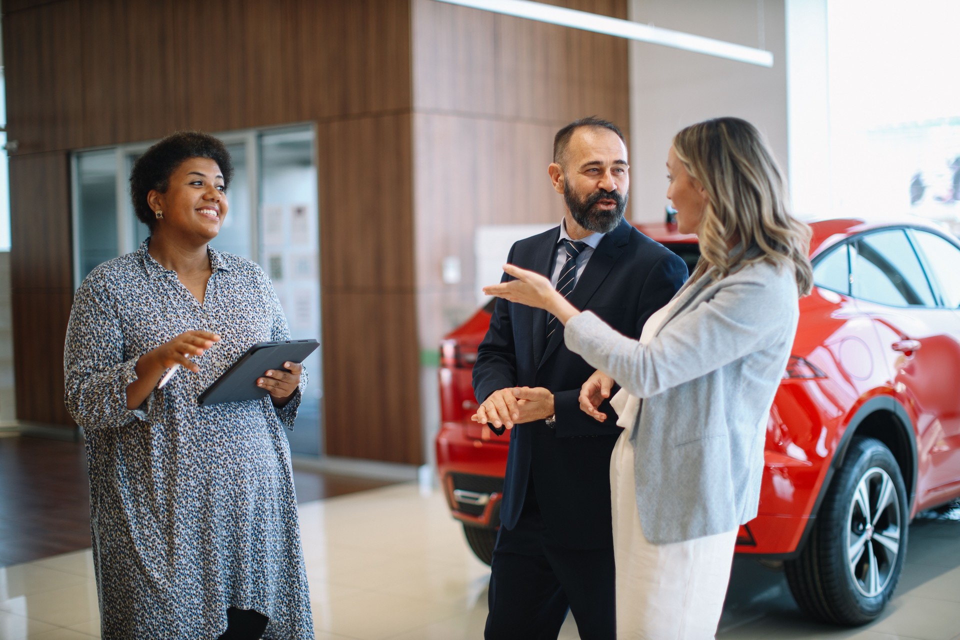 talking to car salesperson in the showroom